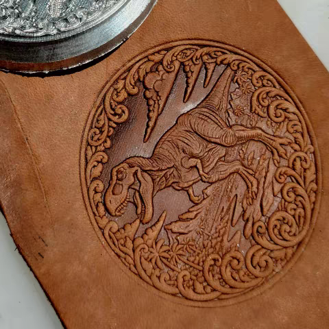Dinosaur leather embossing design with circular scrollwork border